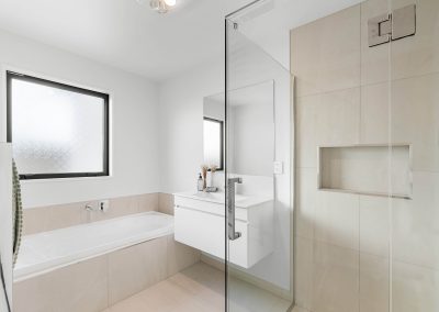 Bathroom with floor/wall tiles, shower, vanity, bath and mirror supplied by Global Supply Solutions in the new builds developed in Silverstream subdivision by Lime Developments.
